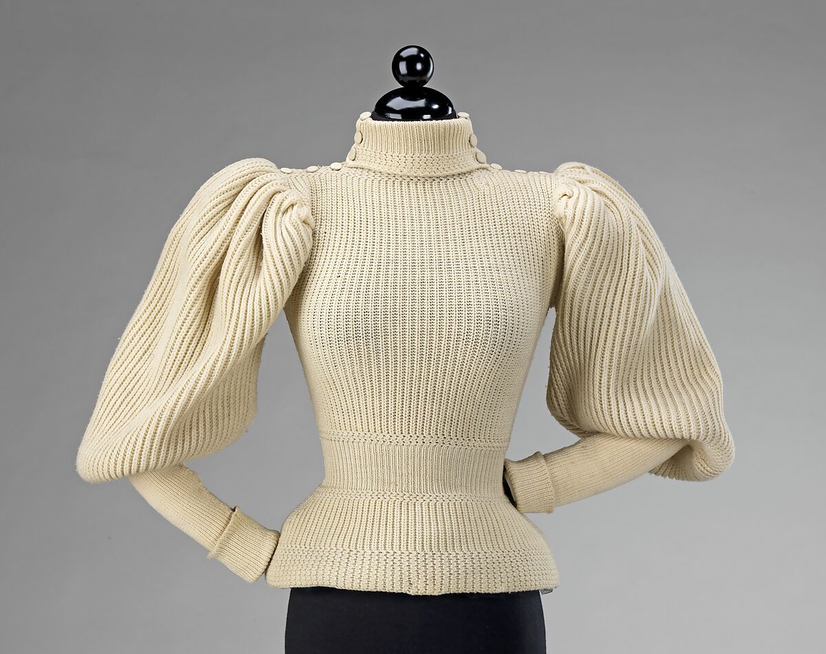 Cream woollen sweater with high, close-fitting collar and gigot sleeves